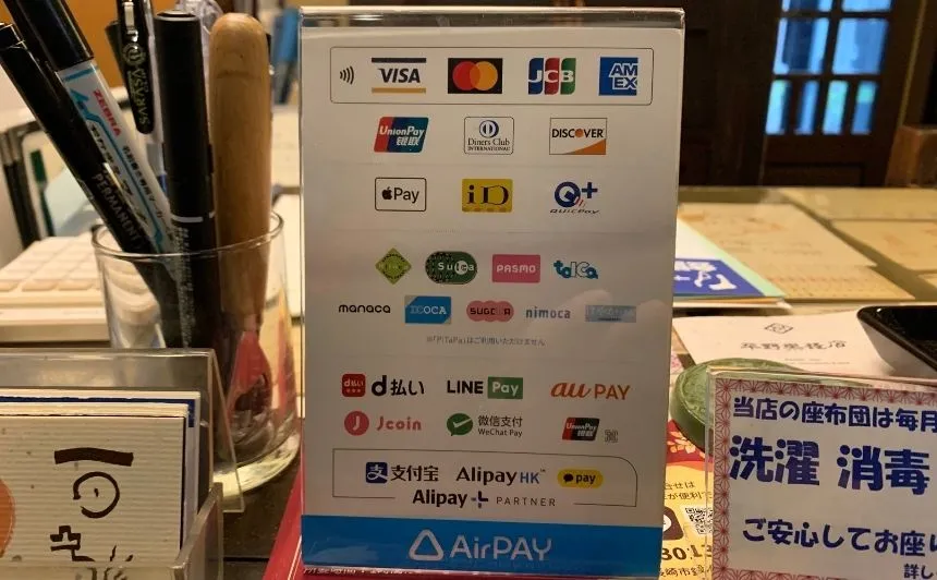 Payment sign at the register with credit card, e-money and QR code logos